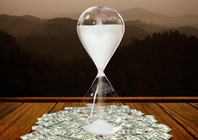 Digital composition of currency flowing through hour glass on wooden plank against mountains in background
