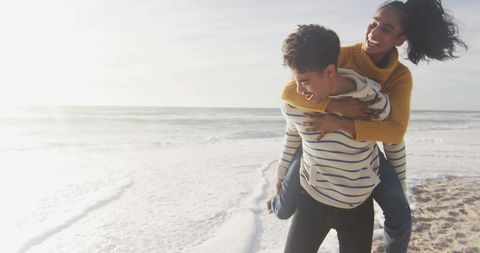 Joyful Piggyback Ride on Sunny Beach