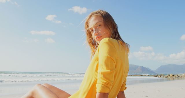 Smiling Woman in Yellow Shirt Relaxing on Sunny Beach - Download Free Stock Images Pikwizard.com