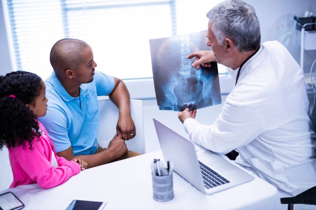 Doctor discussing x-ray report with patient in clinic