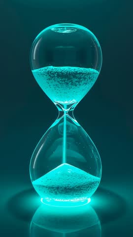 Teal glowing hourglass flowing sand measuring time in vertical cinematic video loop
