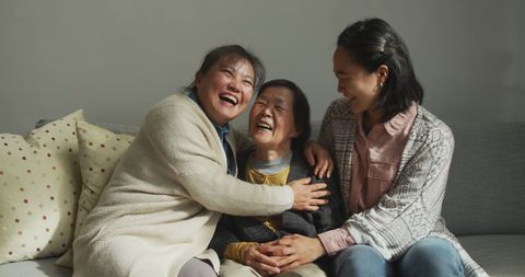 Joyful Multigenerational Asian Family Embracing on Sofa - Download Free Stock Images Pikwizard.com