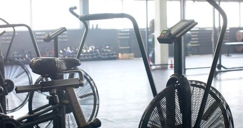 Empty Gym with Sunlit Stationary Bikes at Dawn