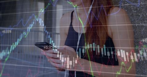 young woman analyzing stock market on mobile with headphones - Download Free Stock Images Pikwizard.com