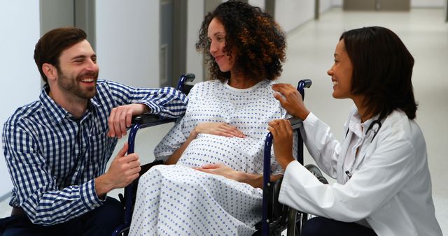 Pregnant Woman in Wheelchair with Partner and Doctor in Hospital - Download Free Stock Images Pikwizard.com