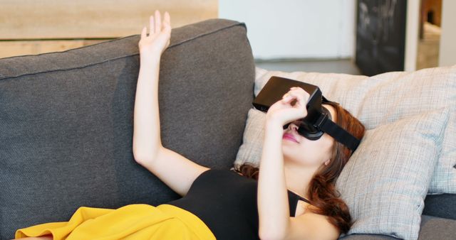 Young Woman Relaxing with Virtual Reality Headset on Couch - Download Free Stock Images Pikwizard.com