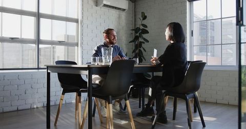 Professionals engaging in partnership discussion in modern office