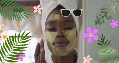 African American Woman Relaxing with Face Mask Spa Treatment