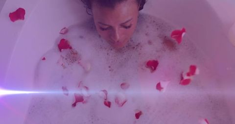 Relaxed Woman in Bathtub with Rose Petals Fostering Calm Atmosphere