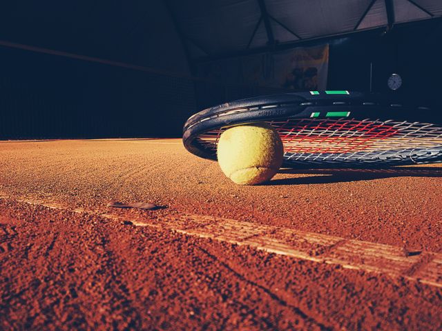 Close up view of Tennis ball and racket on tennis court. Sports and competition concept 