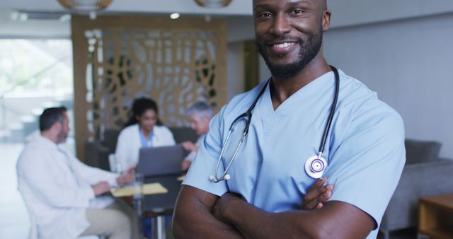 Confident Doctor in Hospital with Team Collaborating in Background - Download Free Stock Images Pikwizard.com