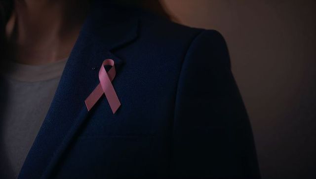 Elegant businesswoman highlighting breast cancer awareness