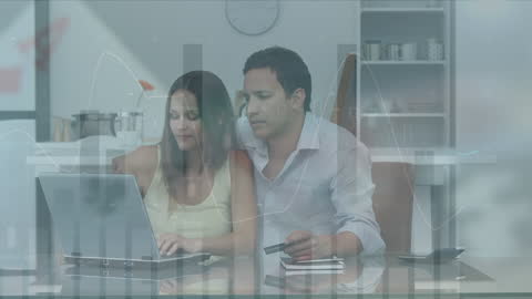 Couple Analyzing Financial Statistics at Home