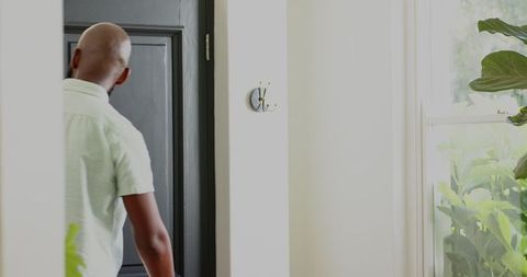 Man in a Modern Home Entryway, Observing Tranquil Interior