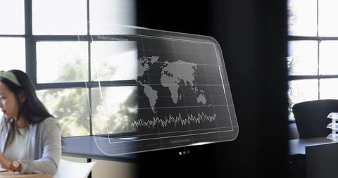 Holographic global analytics overlay in modern office with worker reviewing documents