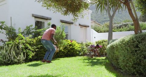 Family gardening: father and daughter enjoying outdoor nature together