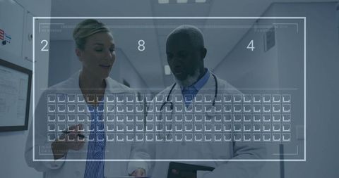 Medical Professionals Discussing Data in Hospital Corridor