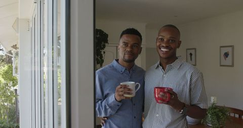 Happy Gay Couple Enjoying Morning Coffee