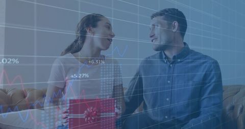 Couple Celebrating with Gift Exchanging Amid Financial Data Overlay