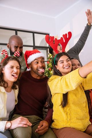 Diverse Friends with Festive Headwear Taking Holiday Selfie