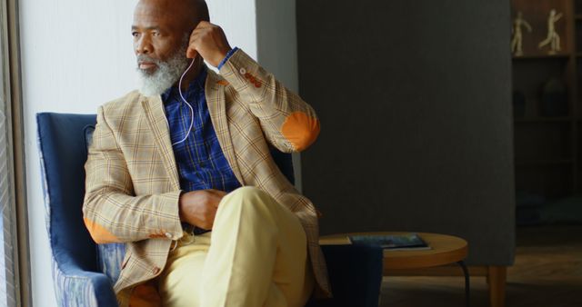 Stylish Senior Man Contemplating Life in Elegant Seating - Download Free Stock Images Pikwizard.com