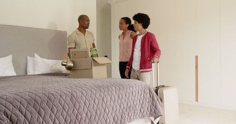 Family Unpacking in Bedroom During Home Move Adventure