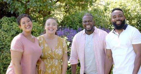 Diverse Friends Laughing Together Outdoors in Lush Garden