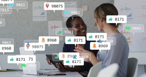 Diverse colleagues collaborating with social media symbols overlay