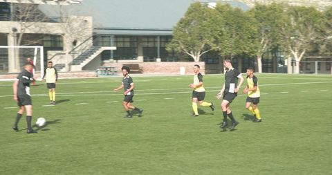 Soccer players displaying teamwork on field during match