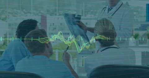 Medical Team Reviewing Tablet with ECG Data Overlay for Clinical Collaboration in Hospital