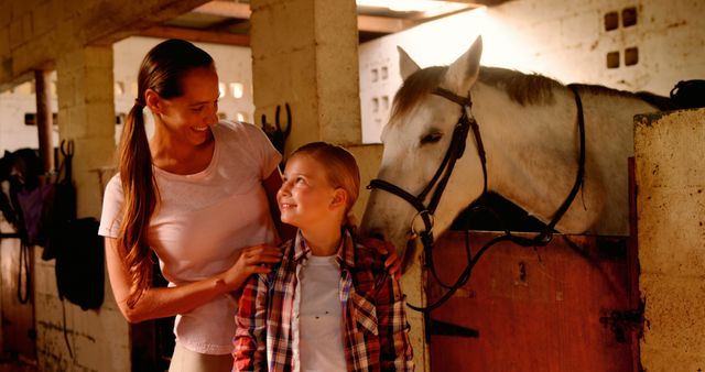 Mother and Daughter with Horse in Stable, Smiling Family Bonding - Download Free Stock Images Pikwizard.com