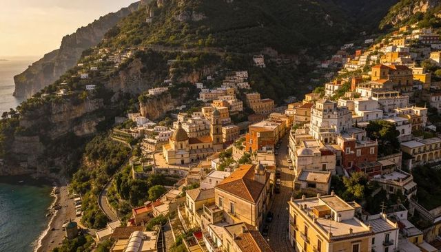 Golden-hour mediterranean cliffside village featuring domed church and terraced rooftops