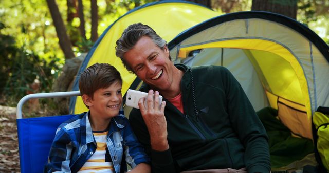 Father and Son Bonding at Camp with Smartphone - Download Free Stock Images Pikwizard.com