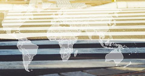World map overlay on urban crosswalk stripes for global mobility concept