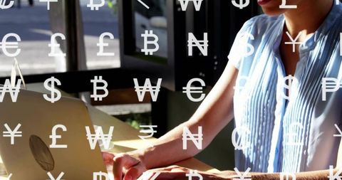 Businesswoman typing on laptop with floating currency symbols in sunlit coworking cafe