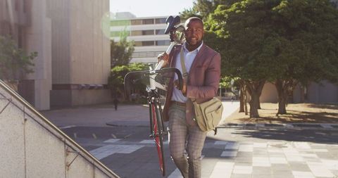 Urban Commuter Carrying Bicycle Upstairs in City