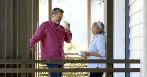 Happy Senior Couple Enjoying Conversation on Porch