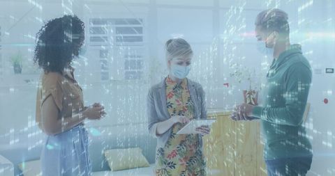 Business Colleagues Analyzing Data with Digital Overlay During Pandemic