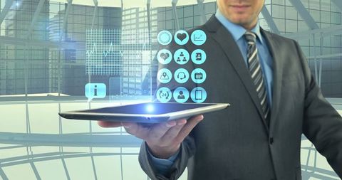 Businessman Presenting Futuristic Tablet Interface in Modern Office - Download Free Stock Images Pikwizard.com