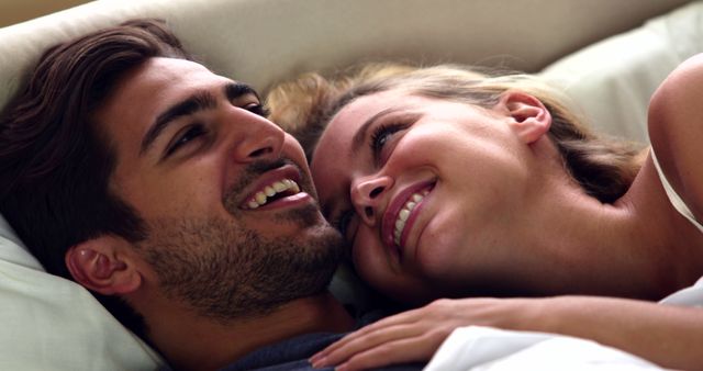 Happy Couple Smiling While Lying on Bed Enjoying Close Moment - Download Free Stock Images Pikwizard.com