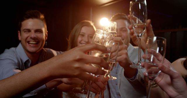 Group of smiling friends sitting on sofa and toasting a glasses of champagne at bar 4k - Download Free Stock Photos Pikwizard.com