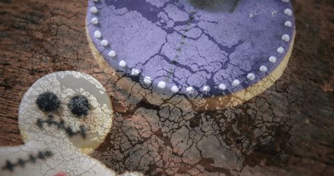 Spooky halloween black cat and skeleton cookies on rustic table