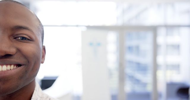 Half Smiling Face of Young African American Man in Bright Office - Download Free Stock Images Pikwizard.com