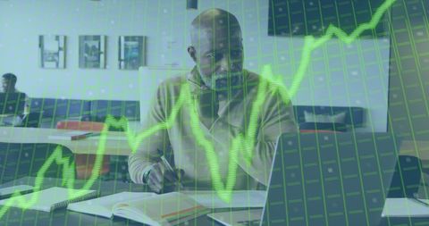 African american businessman analyzing data with inflation text overlay