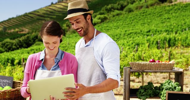 Small Business Owners Using Laptop in Vineyard - Download Free Stock Images Pikwizard.com