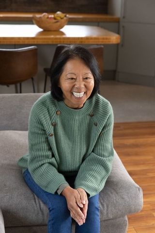 Smiling senior woman relaxing in cozy modern living area