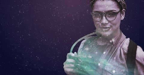 Woman astonished by starry night holding vintage camera