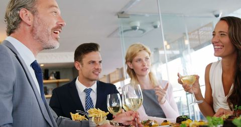 Business Team Enjoying Meal with Lively Conversation