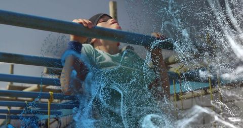Child pulling up on monkey bars with dynamic blue particle overlay, outdoor play strength