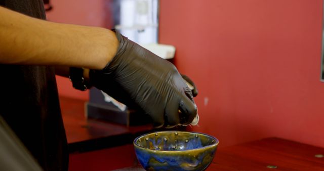 Close-up of Hand Mixing Tattoo Ink in Bowl with Gloves - Download Free Stock Images Pikwizard.com